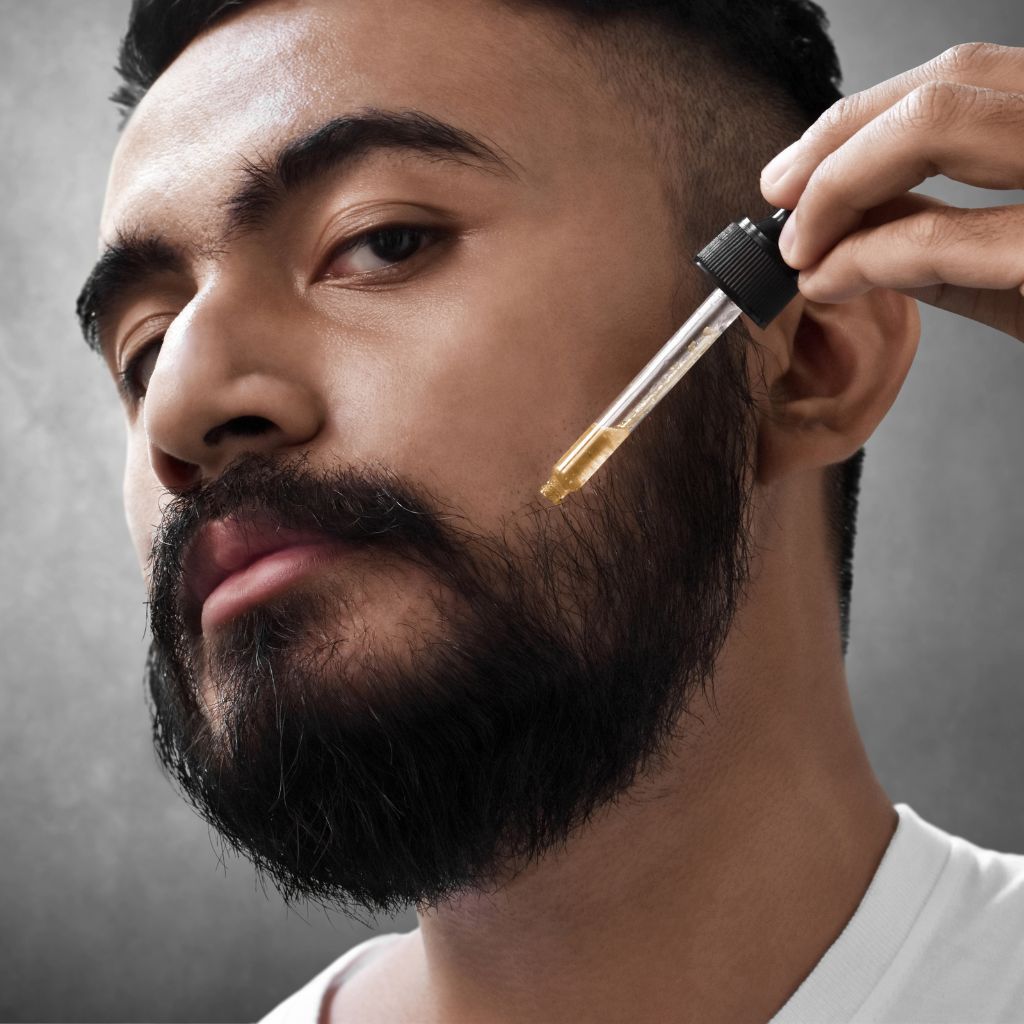 BotaniVie Beard Care for Men. Natural and Sustainable choices for beard care products. Man applying beard oil to his beard.