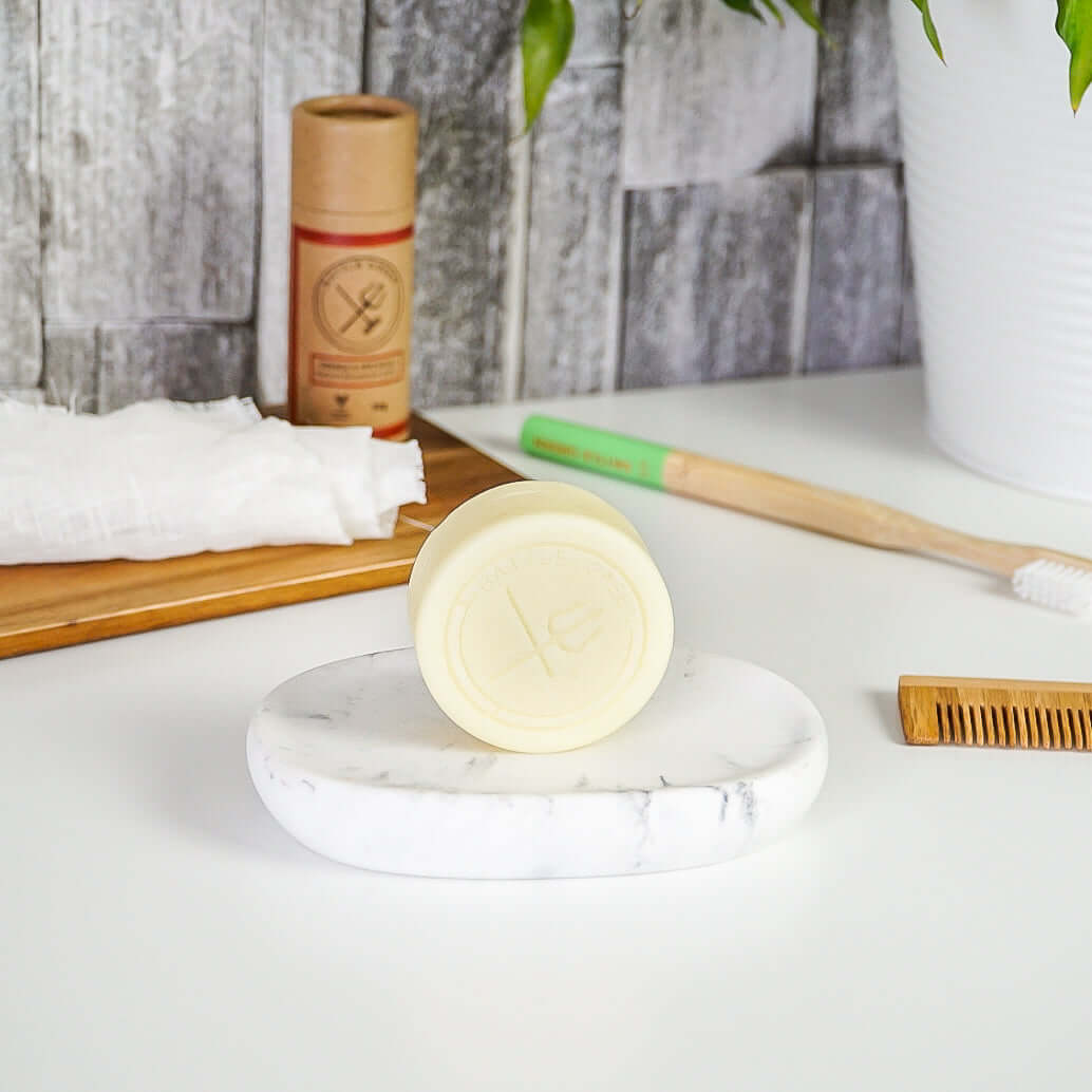 Battle Green Mint Conditioner Bar. uplifting and eco-friendly. On display on a ceramic soap dish.