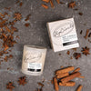 Upcircle Chai Latte Natural Soy Candle flatlay image. chai spices on table with glass soy candle and carboard box.