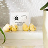The Edinburgh Natural Skincare Co. Sweet Orange and Geranium Solid Bath Oils. Zoomed with petals visible.