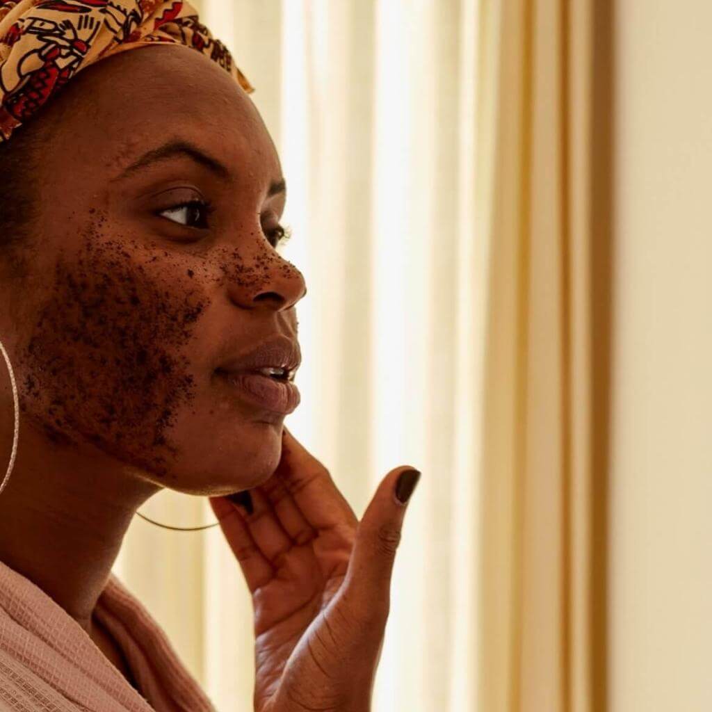 Upcircle Face Scrub Citrus Blend being applied by a model on her face. The coffee grounds are visible in the scrub.