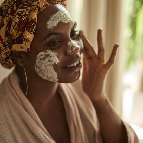 UpCircle - Kaolin Face Mask being applied to the face of a model. The product is being generously applied and white in colour.