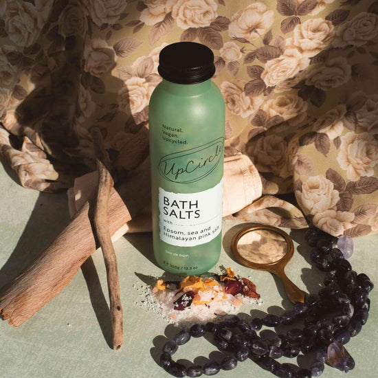 UpCircle Bath Salts with Epsom, Sea and Himalayan Pink Salt, and Rose Petals. Lifestyle Image. With Salts and Driftwood.