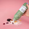 UpCircle Bath Salts with Epsom, Sea and Himalayan Pink Salt, and Rose Petals. Pouring product image on pink background.