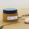 UpCircle - Travel sized Night Cream with repurposed blueberry extract. Lifestyle image from the beach. Sand in the background. Lid on.