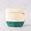 Battle Green certified Organic Cotton Wash Bag. on display. textured background. 2 tone colour, natural white cotton and green cotton.