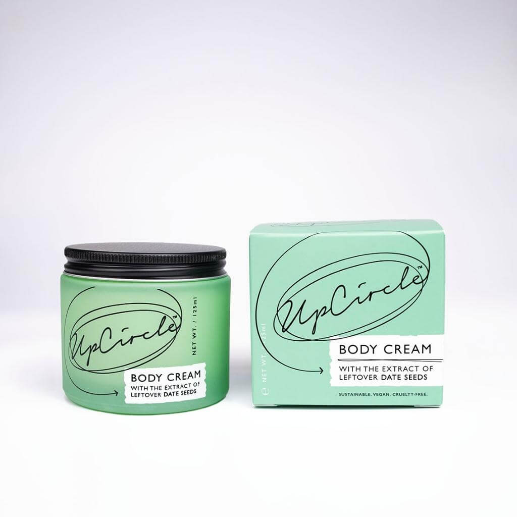UpCircle - Body Cream with the extract of leftover date seeds. Green Glass Jar and Cardboard packaging showing the front.