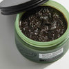 Upcircle Body Scrub containing Lemongrass with the lid off and scrub visible.