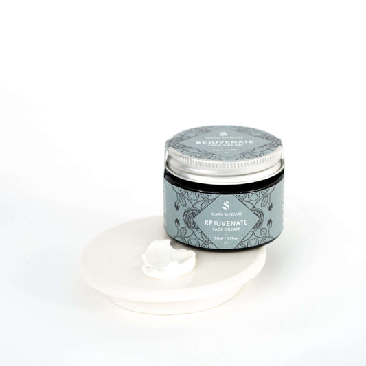 Silvan Skincare. Face Cream. Rejuvenate for Mature Skin. 50ml. Glass Jar with aluminium lid. On a white background. With cream smear showing the white texture