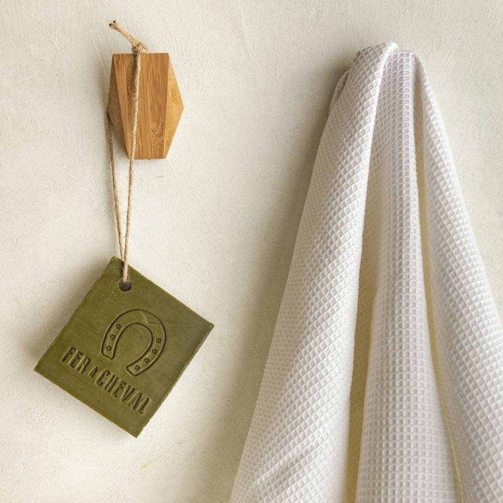 Fer à Cheval Marseille Olive Oil Soap on a Rope. Hanging in shower and bathroom on hook beside towel.