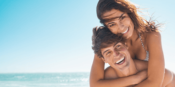 Summer Skincare image with two people at the beach in the summer sun.