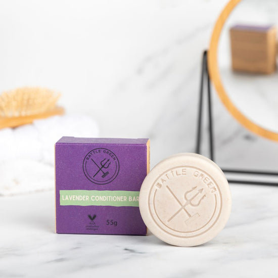 Battle Green Lavender Solid Hair Conditioner Bar. with bar on display with a cardboard box. the packaging is compostable and printed with plant based ink. handmade in small batches, palm oil free, PETA certified Cruelty-Free & Vegan.