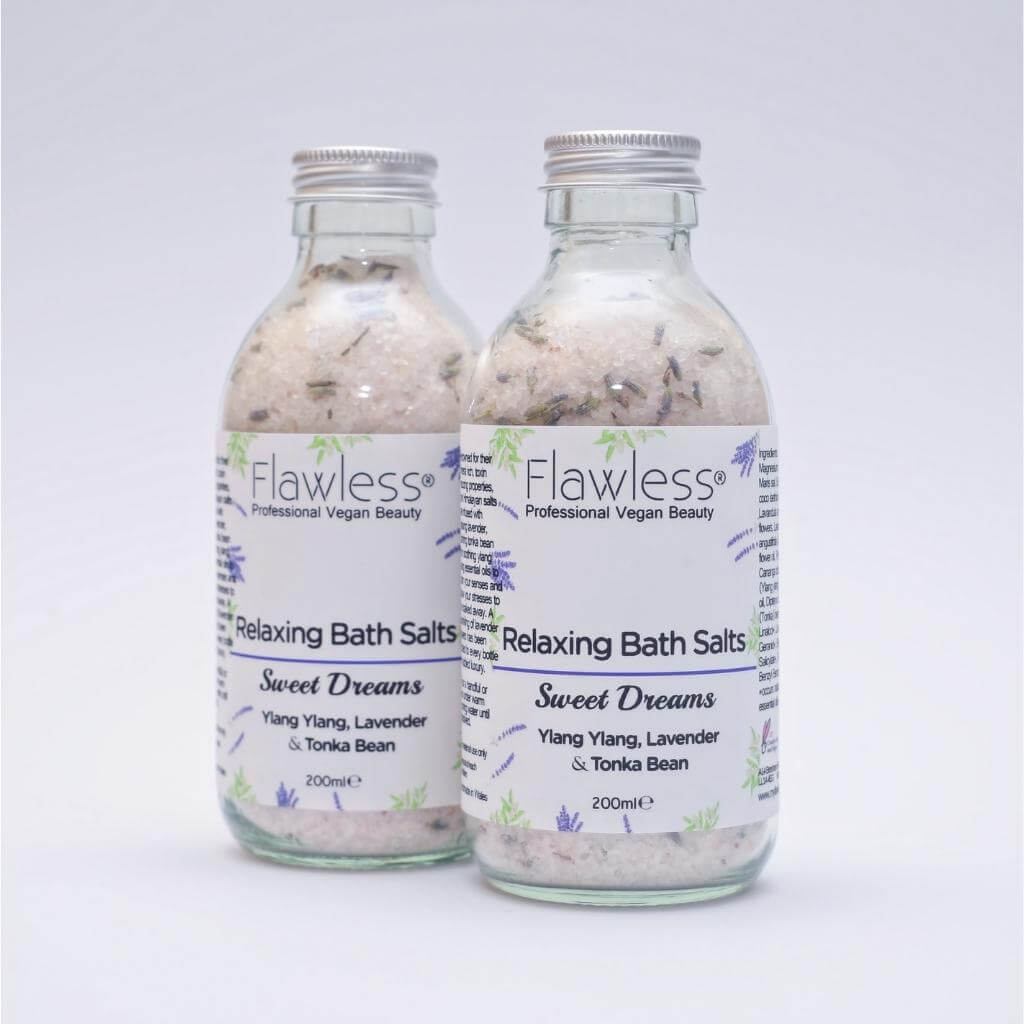 Flawless Professional Vegan Beauty Relaxing Bath Salts glass jars - Sweet Dreams. Ylang Ylang, Lavender & Tonka Bean. On grey Background.