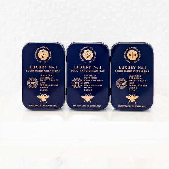 The Edinburgh Natural Skincare Co. Luxury No. 1 Solid Hand Cream Bar. Three tins in alignment.
