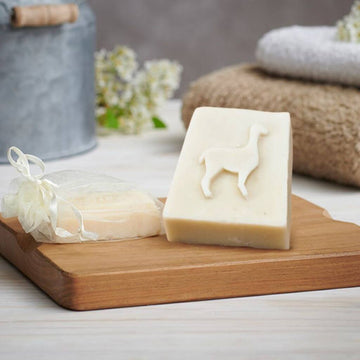 Goats of the Gorge Alpaca Keratin Soap Bar. two varities. Natural and Lemon. Handmade in Somerset UK. Family Run Business. Displayed on Wooden Board.