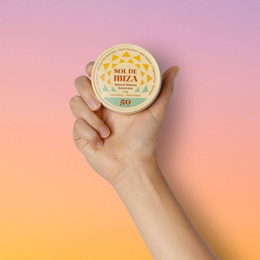Sol de Ibiza Face & Body Vegan Organic Natural Sun Cream SPF50. Cardboard tube. Natural, recyclable, vegan, cruelty free sun protection for all skin types, and adults and children. product held up with aluminium pot/ tin display.