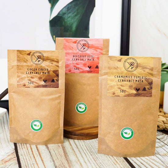 Battle Green Cocoa Ginger Clay Face Mask. on display with other face masks. vegan, and plastic free. waterless product.