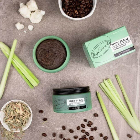 Upcircle Body Scrub with Lemongrass jar and box on a table with the key raw ingredients on display.