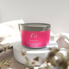 Orli Frangipani Massage Candle in Aluminium tin. Lifestyle image with tin on show. Natural and relaxing way to sooth the body and mind.