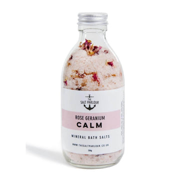 The Salt Parlour - Rose Geranium CALM Mineral Bath Salts glass bottle with aluminium lid. The salts show the rose petals inside.