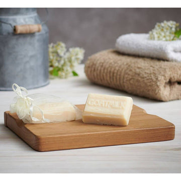 Goats of the Gorge Goats Milk Mini Soap Bar. on display with natural biodegradable silk organza bag on a wooden board.