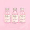 Flawless Professional Vegan Beauty Toner - Rose and Lavender. Three glass jar with aluminium lid on pink background.