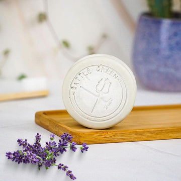Battle Green Lavender & Tea Tree Vegan Natural Deodorant Bar. natural ingredients. on a bamboo board with deodorant bar standing up. plastic free. With Lavender in the front of the image.