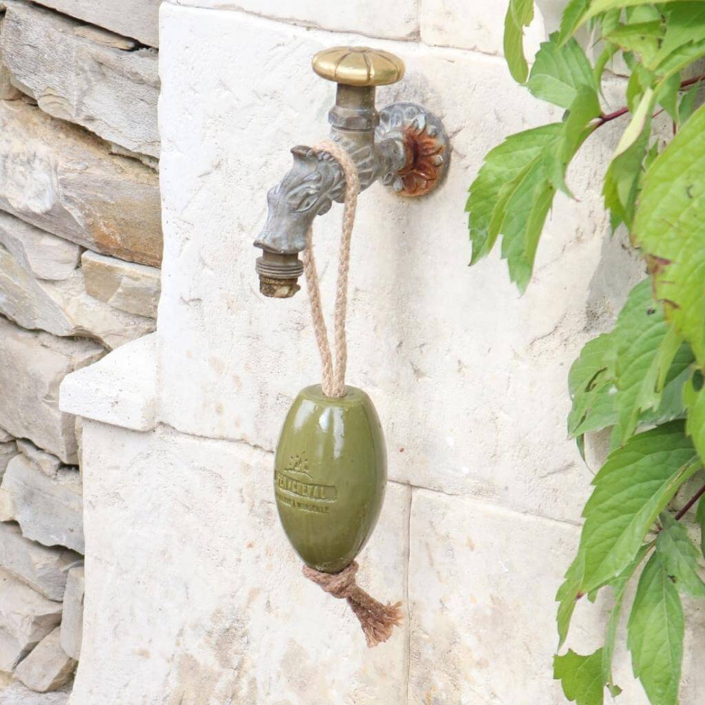 Fer à Cheval Olive of Marseille Soap on a Rope. Lifestyle. Soap hanging from water tap