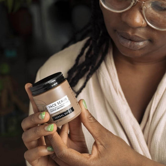 Upcircle Face Scrub Herbal Blend being held by a model in her hands.