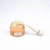 UpCircle Eye Roller with Upcircle Eye Cream. Using spatula to remove eye cream. On white background.