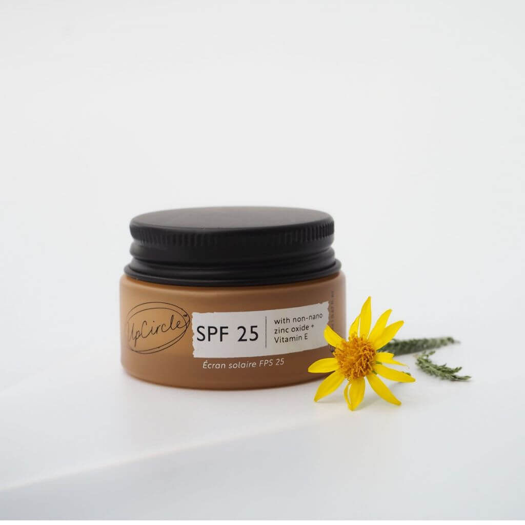 pCircle - SPF 25 Mineral Sunscreen with non-nano zinc oxide and Vitamin E. Travel Size 20ml. With yellow flower and white background. Lid on.