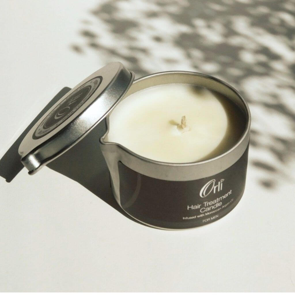 Orli Hair Treatment Candle - For Men in Aluminium tin. Flatlay. With lid off and hair oil visible.