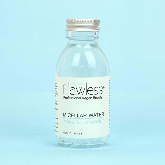 Flawless Professional Vegan Beauty Micellar Water - Aloe and Lavender. Glass Bottle with aluminium lid on blue background.