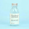 Flawless Professional Vegan Beauty Micellar Water - Aloe and Lavender. Glass Bottle with aluminium lid on blue background.