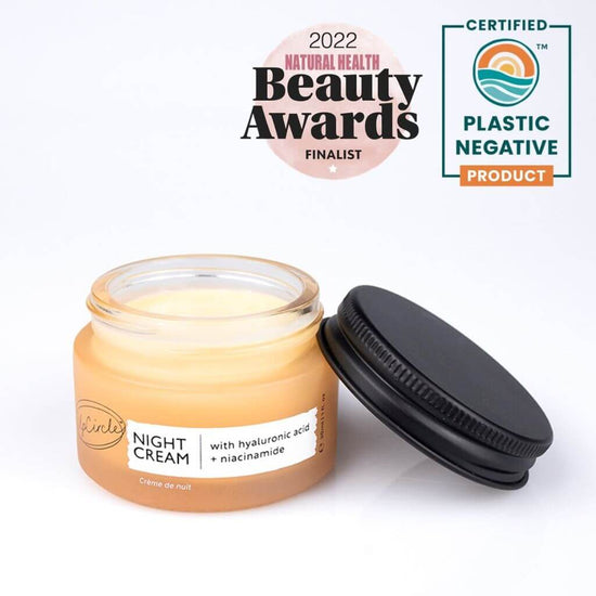 UpCircle - Travel sized Night Cream with repurposed blueberry extract. Orange Glass Jar and Cardboard packaging showing the front. Awarded 2022 Natural Health Beauty Awards Finalist. Certified Plastic Negative Product.