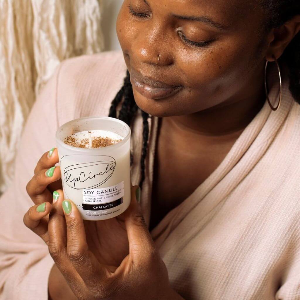 Upcircle Chai Latte Natural Soy Candle lifestyle image. Model holding chai soy candle in her hands.