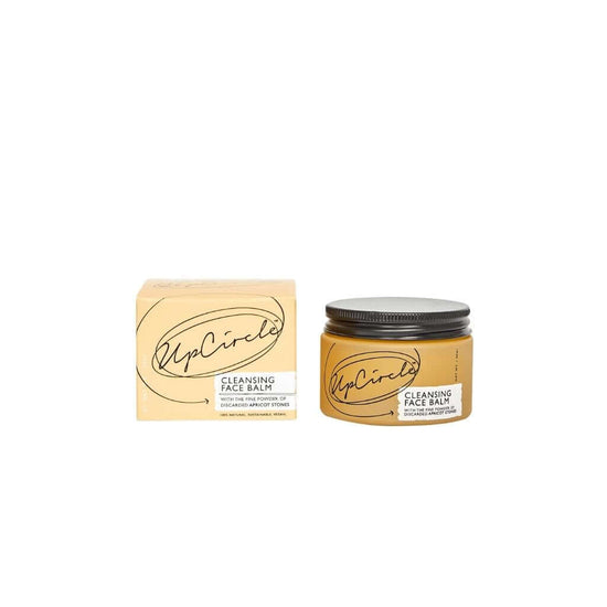 Upcircle Cleansing Face Balm jar and box fronts on show without a background. Text on box with the fine powder of discarded apricot stones.