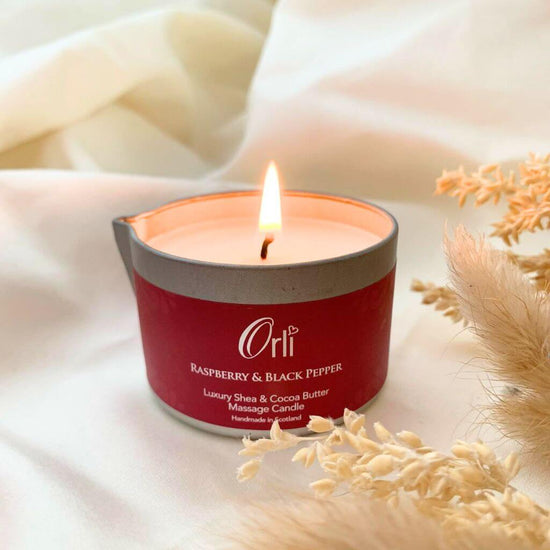 Orli Raspberry & Black Pepper Massage Candle in Aluminium tin. with warming Clove, a touch of Jasmine, Patchouli, Musk, and Amber aromas.