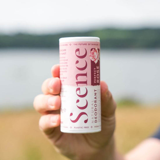 Scence Perfect Rose Natural Solid Deodorant. Lifestyle Image, product being held outdoors. Vegan Certified. made in Cornwall UK. Size: 75 grams.