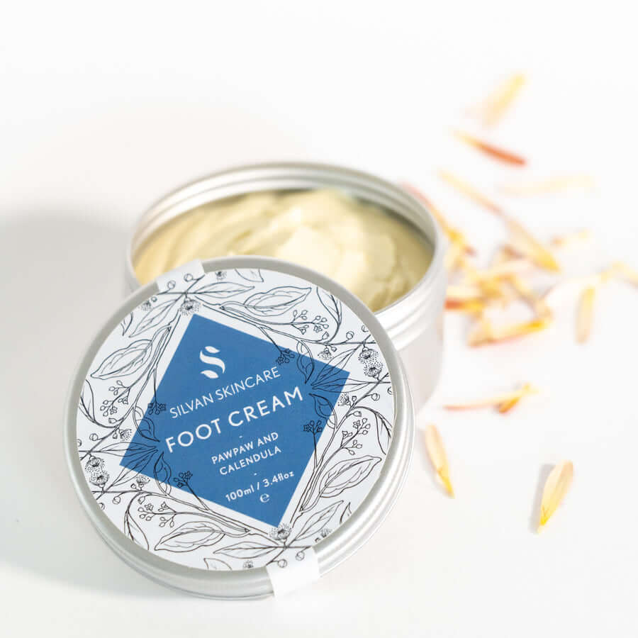 Silvan Skincare. Foot Cream. Foot Cream with Pawpaw and Calendula. 100ml. Aluminium tin and lid. On a white background. Lid partially off and product visible.