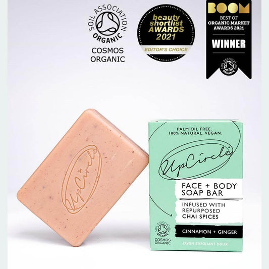 Upcircle Cinnamon and Ginger Chai Face and Body Soap Bar. With soap bar leaning on cardboard box with a white background. Awards from: Organic Soil Association, Beauty Shortlist Awards 2021 Editor's Choice, Boom Best of Organic Market Awards 2021 Winner.