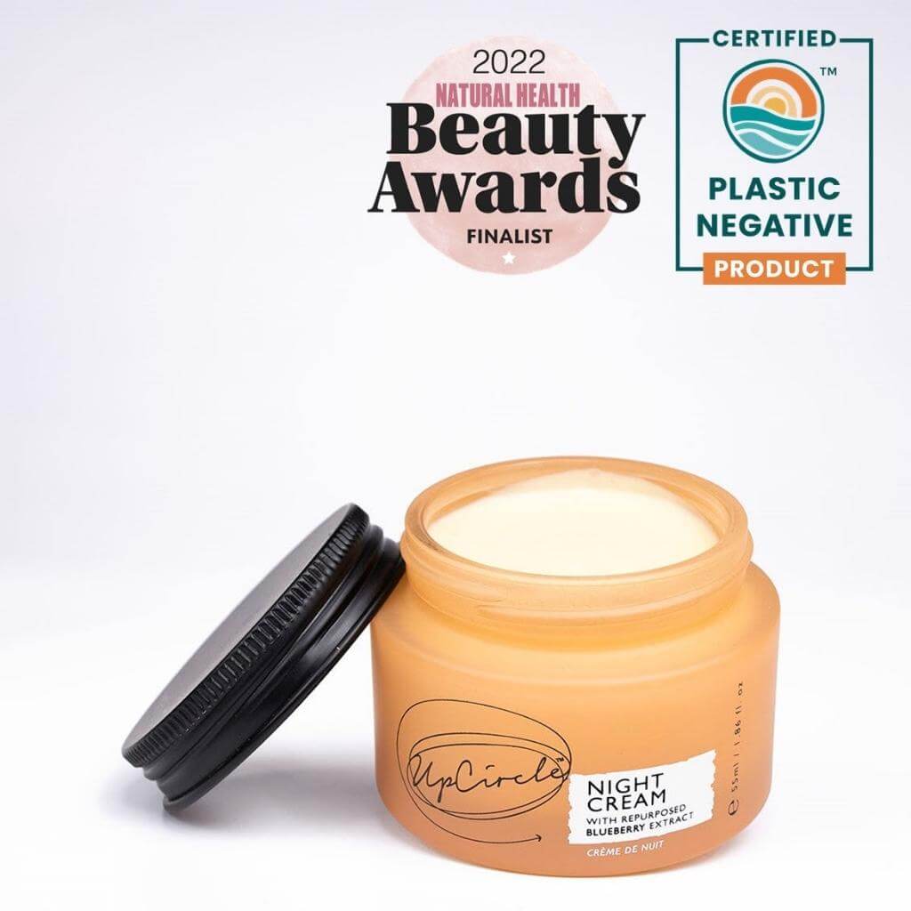 UpCircle - Night Cream with repurposed blueberry extract. Orange Glass Jar and Cardboard packaging showing the front. Awarded 2022 Natural Health Beauty Awards Finalist. Certified Plastic Negative Product.