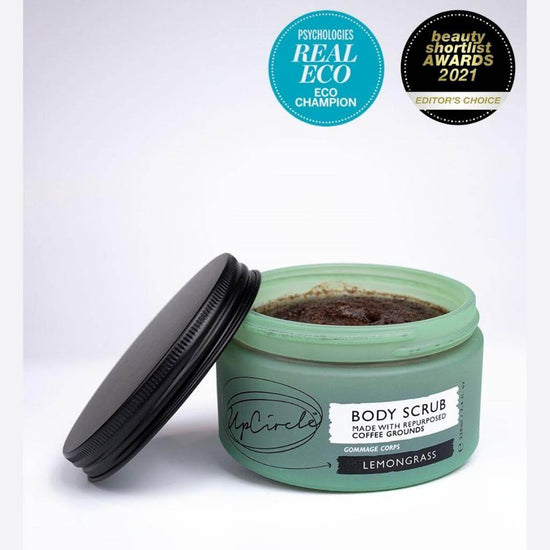 Upcircle Body Scrub containing Lemongrass with lid off and coffee grounds scrub visible on a white background. Awards: Psychologies Real Eco - Eco Champion, Beauty Shortlist Awards 2021 Editor's Choice.