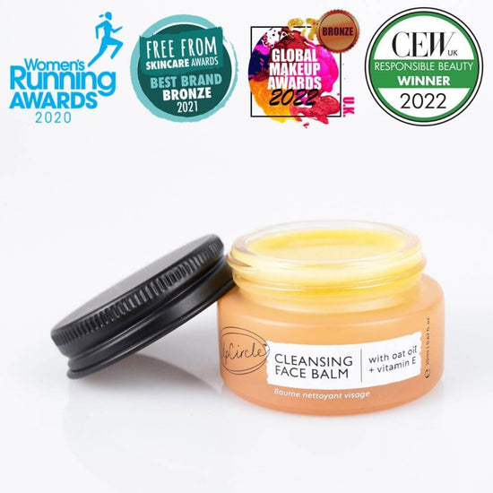Upcircle Cleansing Face Balm Travel Size with lid off and yellow balm visible inside with a white background. Awards: Women's Running Awards 2020, Free From Skincare Awards Best Brand Bronze 2021.