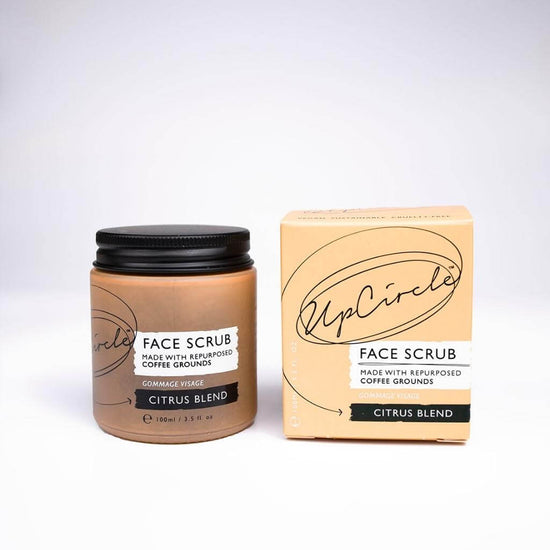 Upcircle Face Scrub Citrus Blend with Jar and Cardboard Box fronts visable. Face Scrub made with repurposed coffee grounds. With a white background.