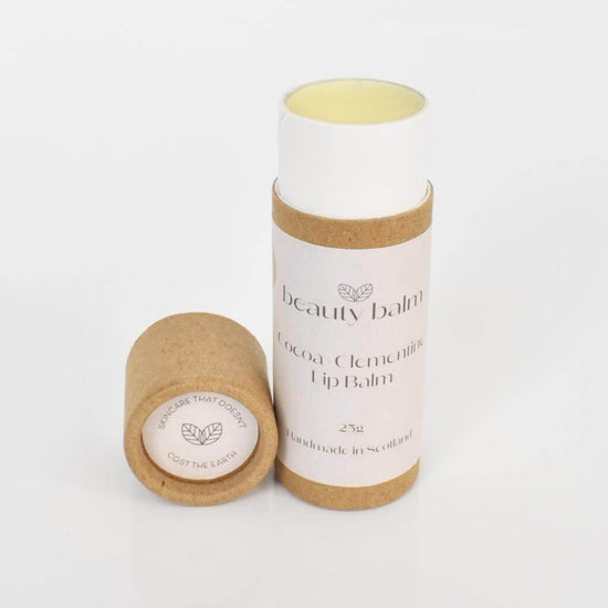 Beauty Balm Cocoa and Clementine Lip Balm in Cardboard Tubes. Lid off balm with a white background