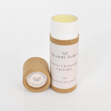 Beauty Balm Cocoa and Clementine Lip Balm in Cardboard Tubes. Lid off balm with a white background