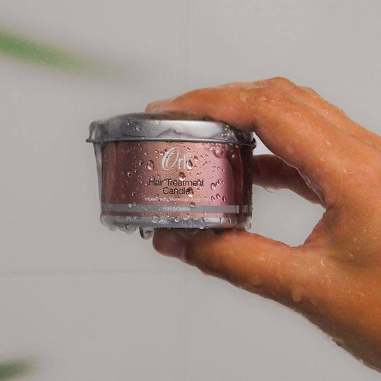 Orli Hair Treatment Candle - For Women in Aluminium tin being held by a hand. treat yourself to luscious locks.